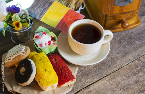 Belgium patriotic breakfast - King's Feast. cookies with red black and yellow glaze as the Belgian flag colors. cup of coffee and a homemade flag of Belgium photo