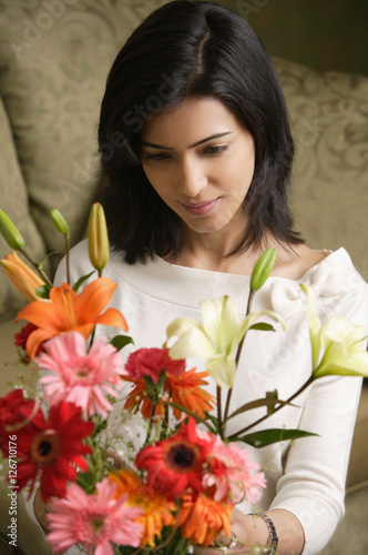 Photography woman looks down at bouquet of flowers