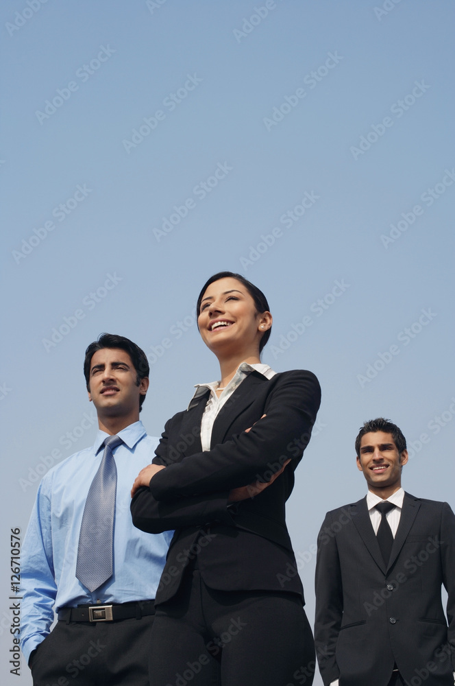 three business colleagues, standing three business colleagues, standing