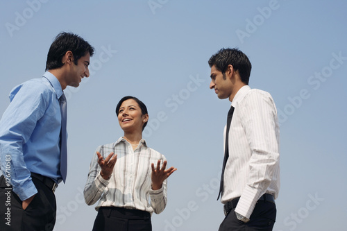 three business colleagues, conversing