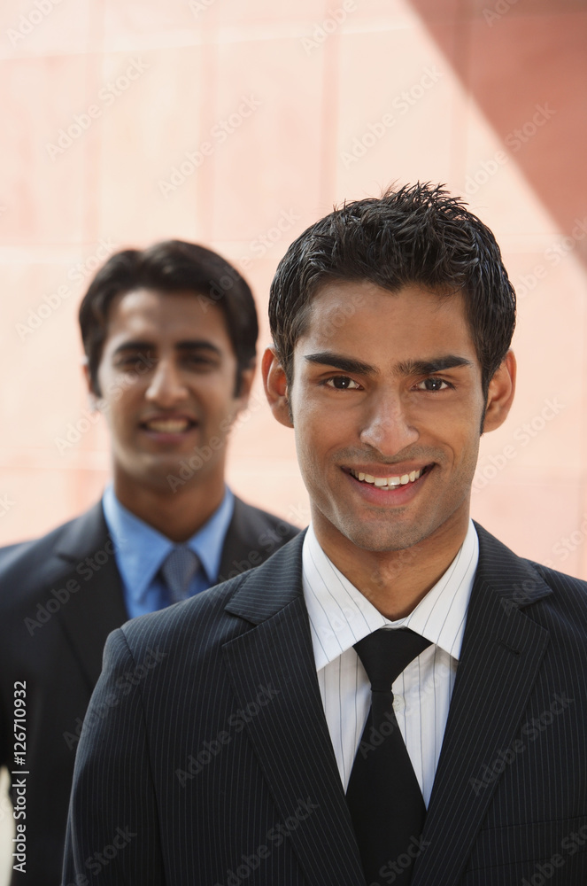 two businessmen smiling (vertical) two businessmen smiling (vertical)