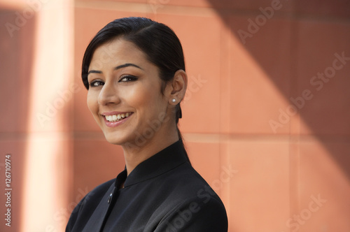 Photography woman with pearl earrings smiling at camera (horizontal)