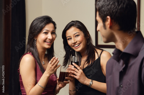 Photography two woman, one man at a party