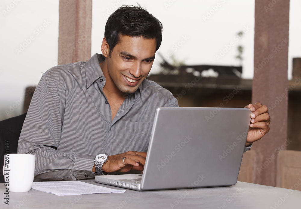 man working at laptop computer man working at laptop computer