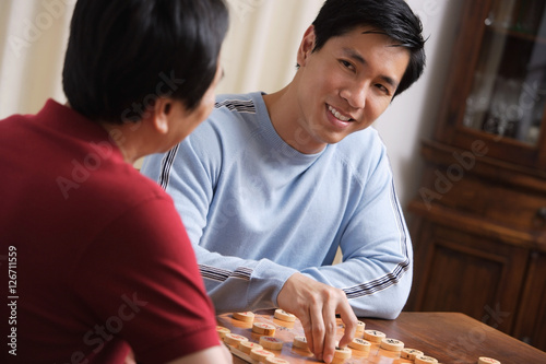 Father and son playing board game