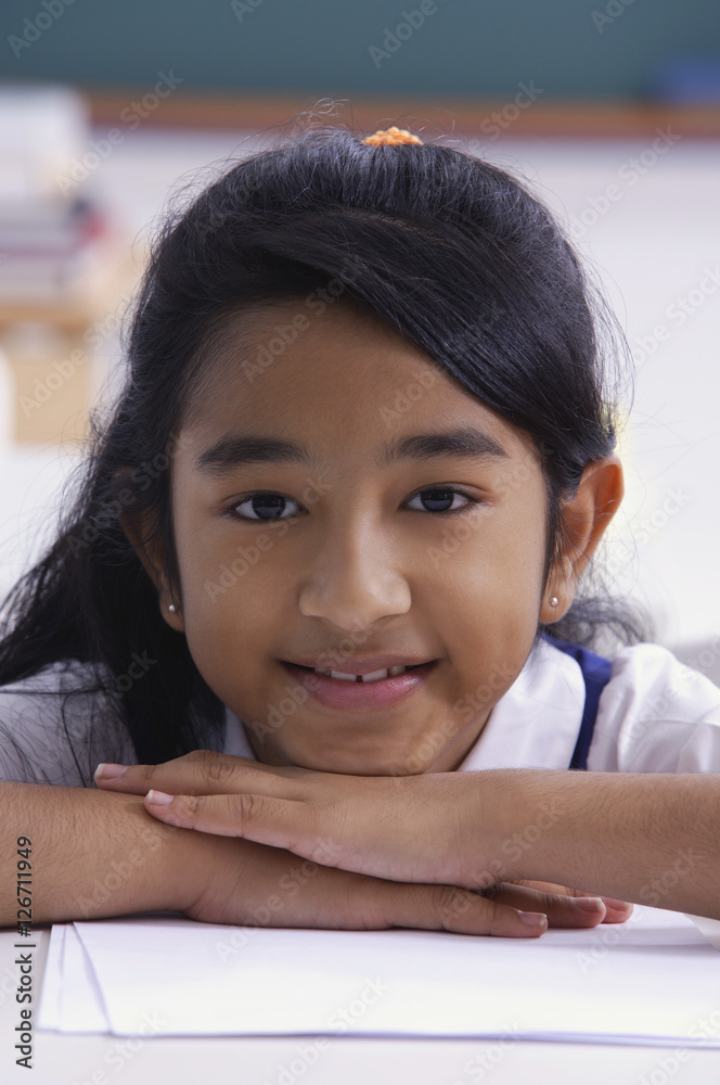 girl resting chin on folded hands girl resting chin on folded hands