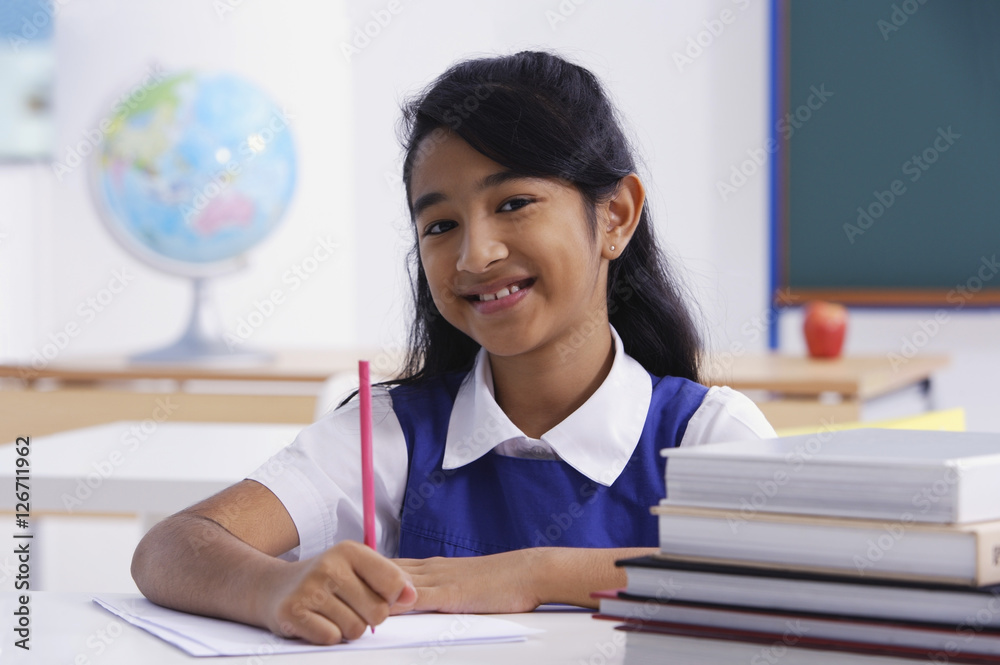 girl at desk with red pencil and books (horizontal) girl at desk with red pencil and books (horizontal)