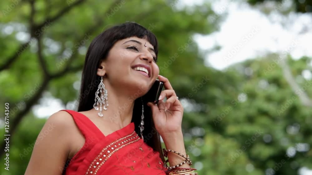 MS LA Young woman wearing sari, talking on mobile phone in park MS LA Young woman wearing sari, talking on mobile phone in park
