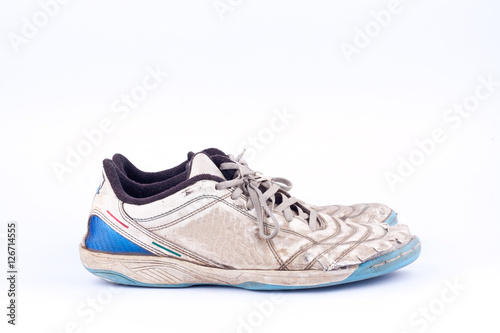 Old blue worn out futsal sports shoes on white background isolated 