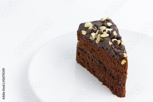 chocolate cake with almond topping on white background