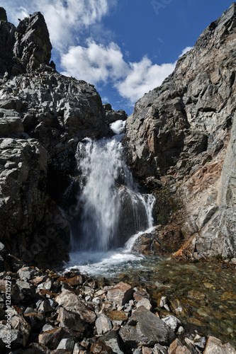 Waterfall on mountain river and blue sky with clouds © Alexander Piragis