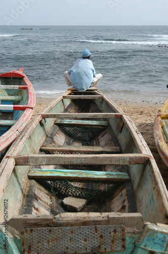 Lebu fisherman waiting for the tide at Ouakam Beach in Dakar , Senegal, at the fisherman's village. photo