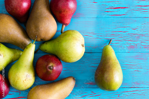 Stained blue and crackled surface with pears photo