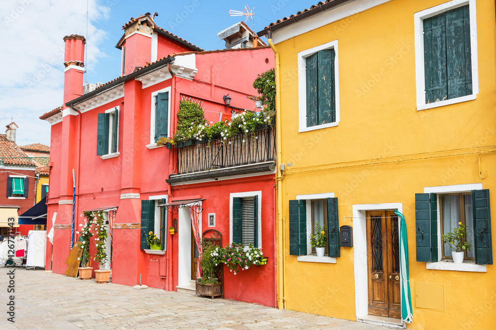 Red and yellow houses in Burano Island (Venice, Italy). All potential trademarks are removed.