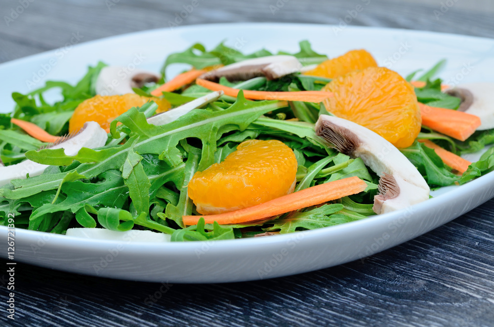salad arugula in white dish on table salad arugula in white dish on table