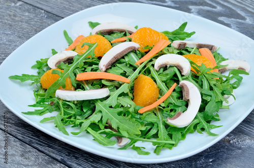 salad with arugula in dish on table
