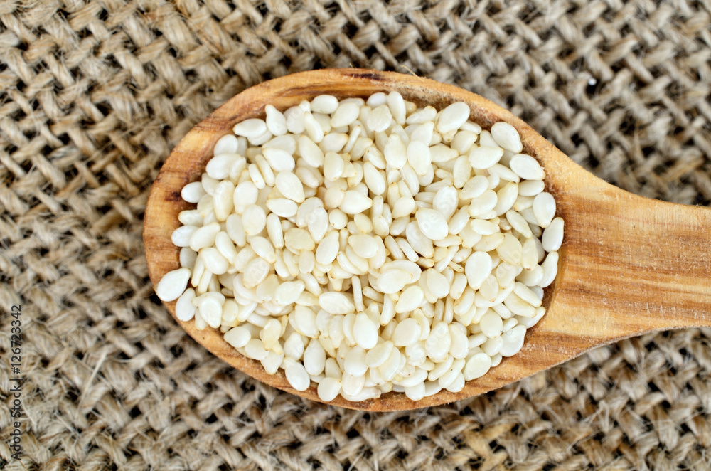 sesame in spoon on burlap sesame in spoon on burlap