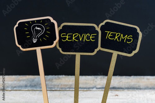 Concept message SERVICE TERMS and light bulb as symbol for idea