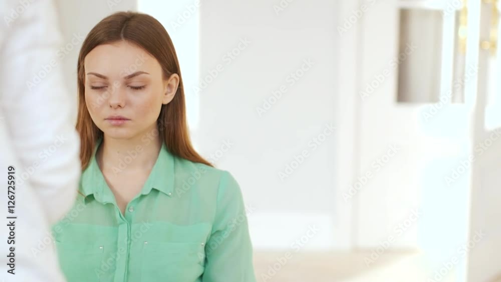 Makeup artist makes a girl beautiful makeup in white room Makeup artist makes a girl beautiful makeup in white room