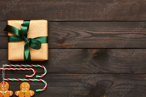 Christmas present and decoration on wooden background