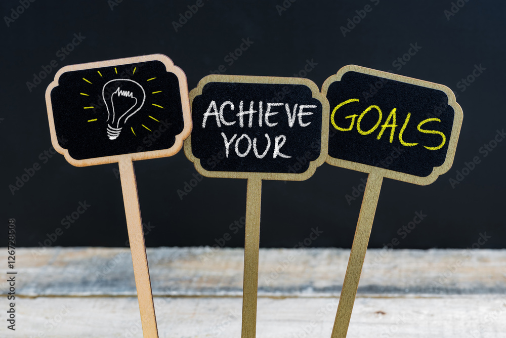 Concept message ACHIEVE YOUR GOALS and light bulb as symbol for idea