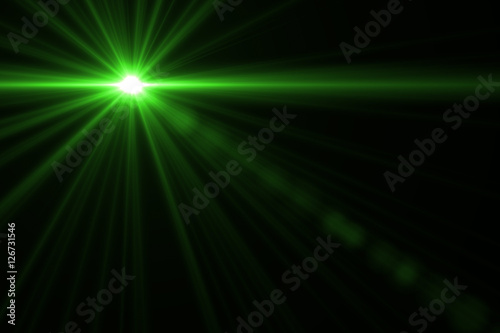 abstract lens flare green light over black background