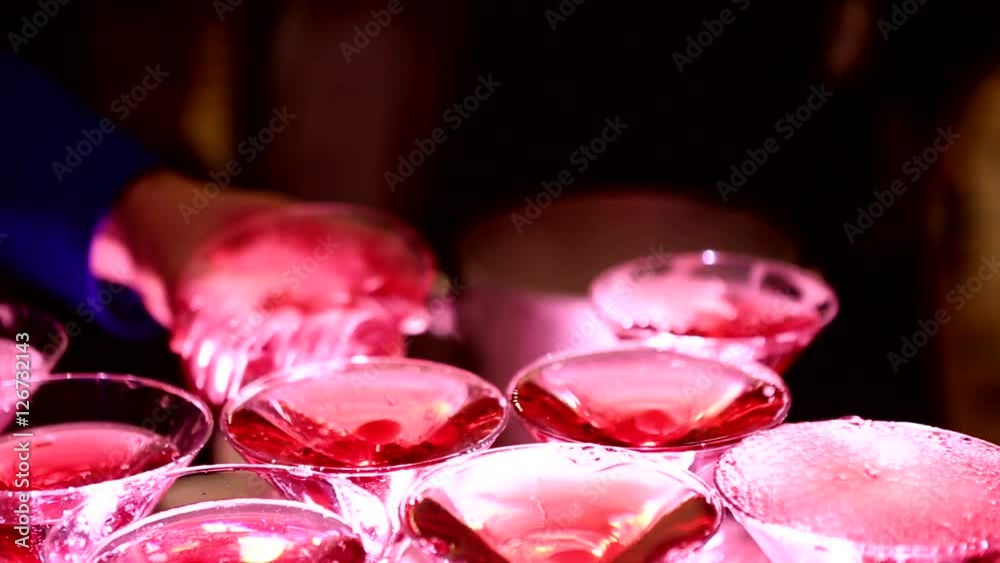 Festive champagne bubbling in the glasses on a serving table. Fun festive alcohol at the party. Celebration with alcohol. Festive champagne bubbling in the glasses on a serving table. Fun festive alcohol at the party. Celebration with alcohol.