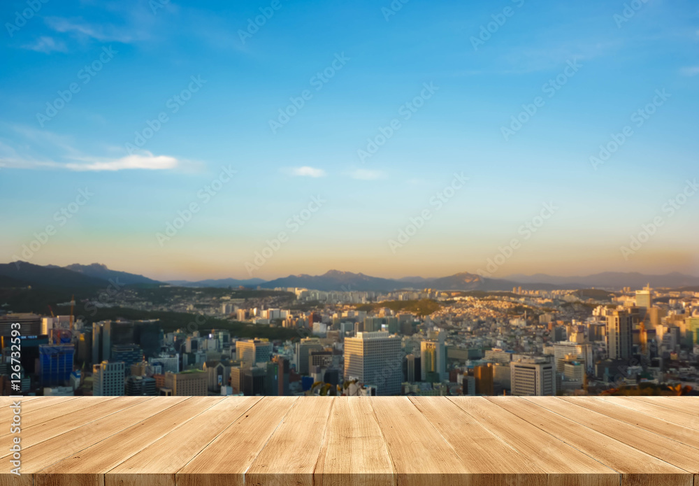 Empty wood table and blurred Perspective sunset city view with t Empty wood table and blurred Perspective sunset city view with t