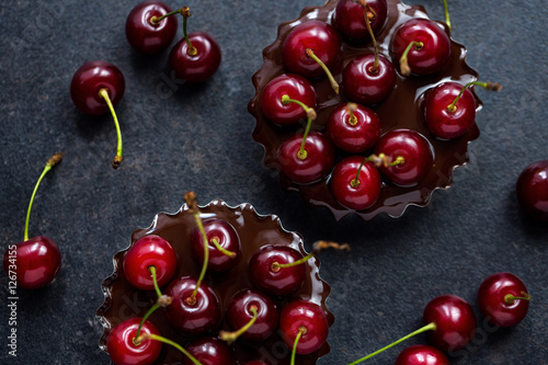 red cherry in a chocolate tart. photo