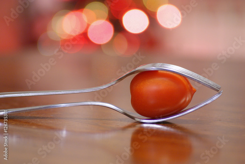 silver fork and red tomato