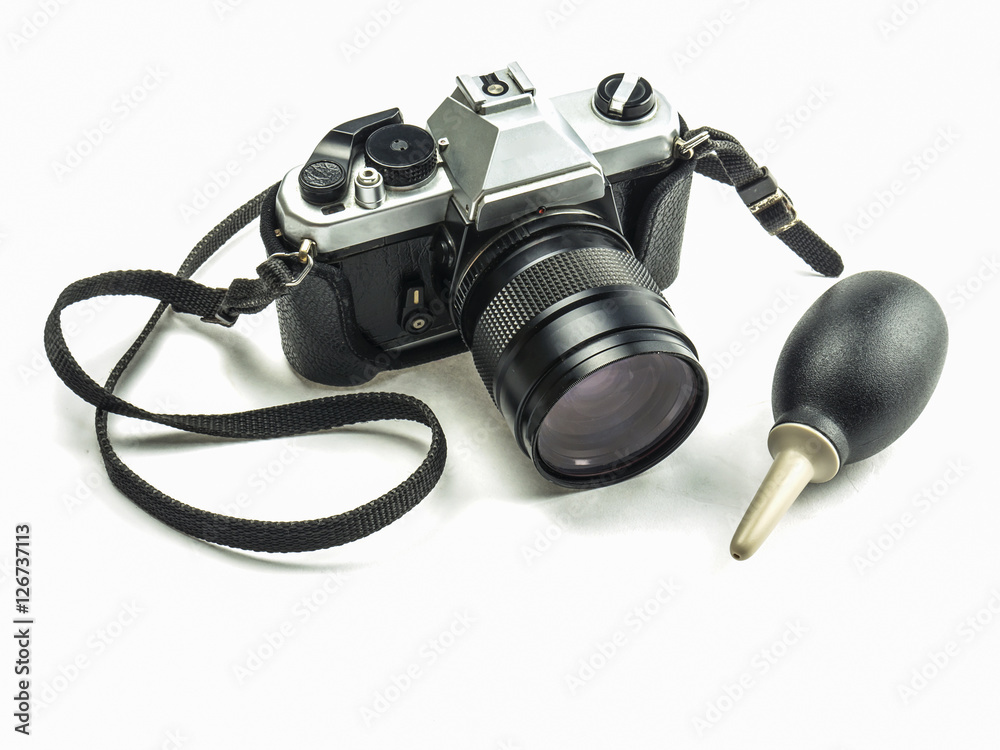 Old fashioned single lens reflex camera with rubber blower pump cleaner isolated over white background Old fashioned single lens reflex camera with rubber blower pump cleaner isolated over white background