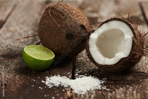 Refreshment water ingredients. Weight loss concept. Exotic coconut and lime on wooden background. 