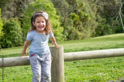 outdoor portrait of young happy child girl on natural background