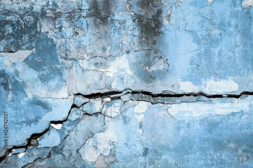 plastered wall with peeling plaster with huge crack