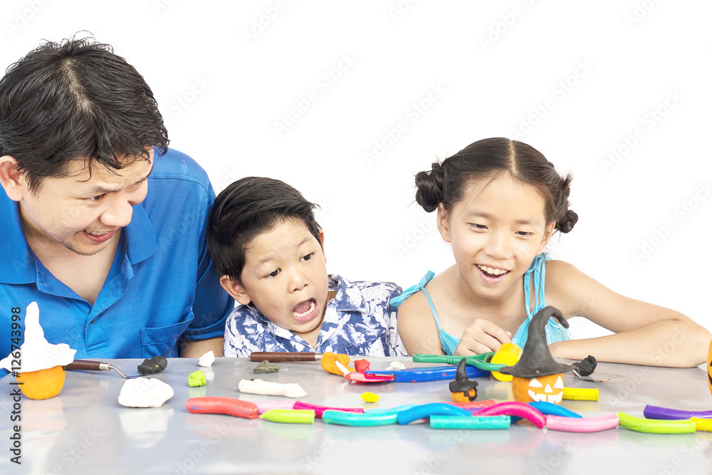 Fototapeta premium Father is playing clay toy with kid