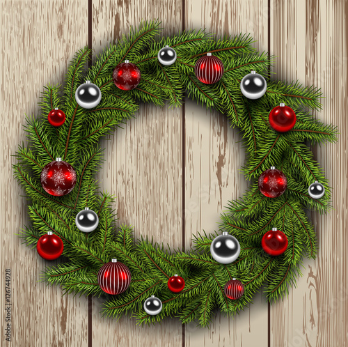 Christmas wreath on wooden board background