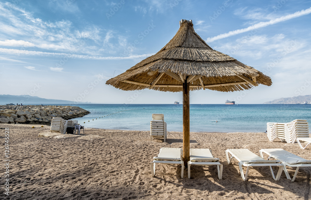 Central public beach of Eilat - famous resort city in Israel. Eialt is Israeli southernmost tourist city, located on the northern shores of the Red Sea.  
