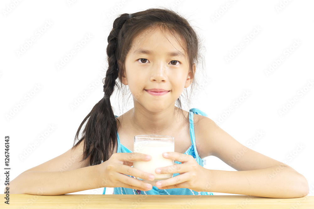 Asian girl is drinking a glass of milk over white background Asian girl is drinking a glass of milk over white background