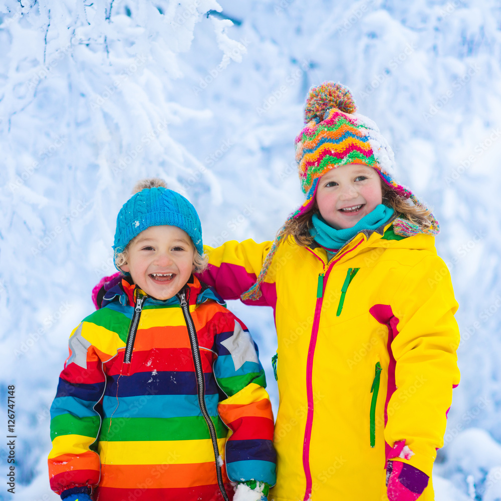 Kids play with snow in winter park Kids play with snow in winter park
