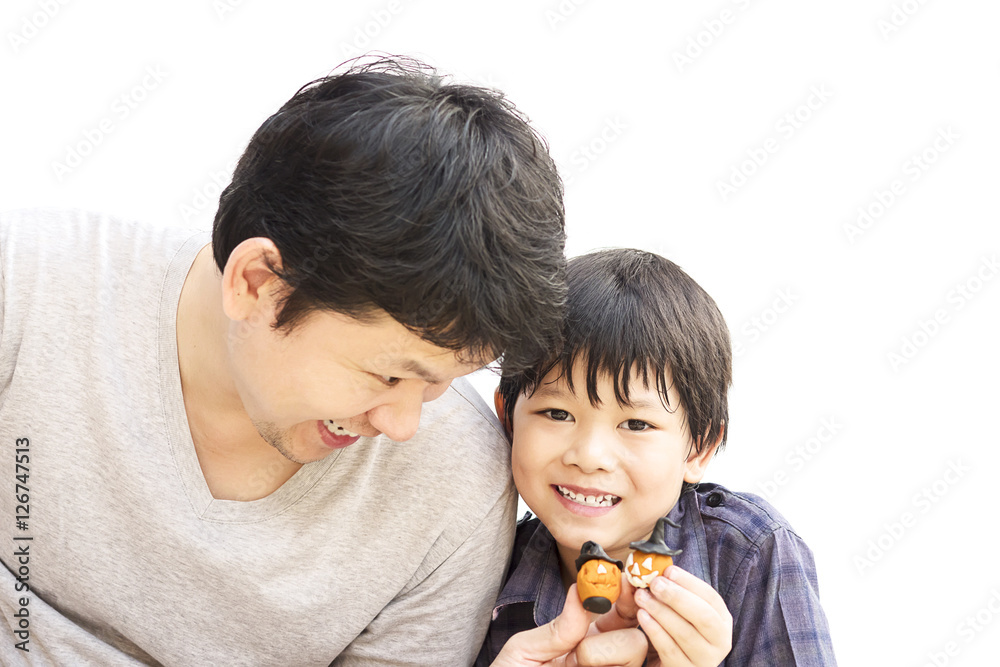 Father is playing Halloween clay with his son over white background Father is playing Halloween clay with his son over white background
