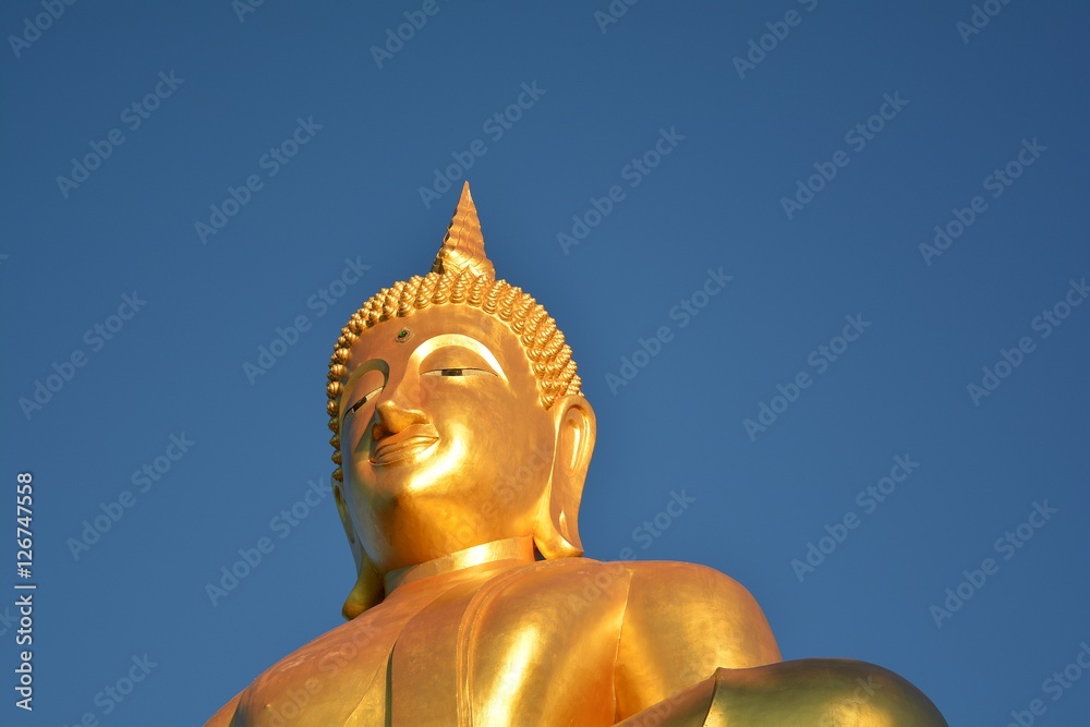 Buddha statue/ Buddha statue on a pedestal blue sky background Wait for believers to worship