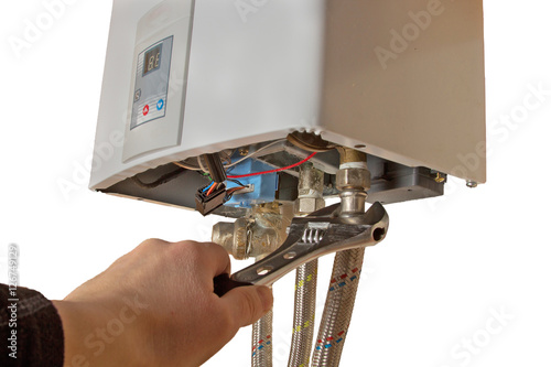 repair of the gas water heater with adjustable wrench. isolated on white