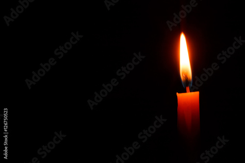 Candle on black background