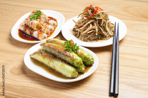 Various type of Chinese food and chopsticks on table
