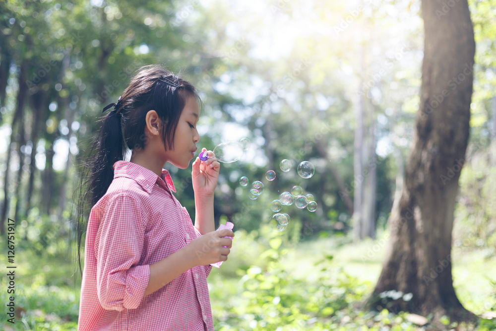 Asia cute girl Playing blowing balloons at the Park Asia cute girl Playing blowing balloons at the Park