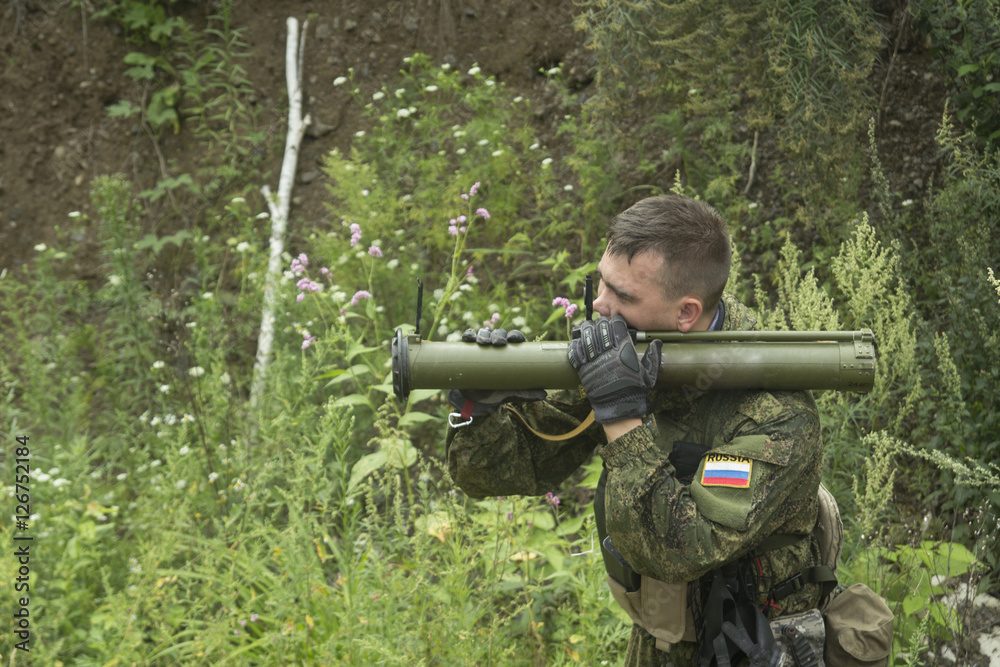 Fototapeta premium Soldier shoots from a grenade launcher