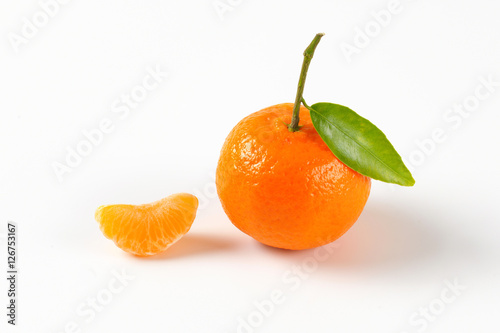 whole mandarin orange and one segment