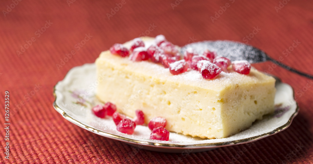 Cake with pomegranate seeds on red background Cake with pomegranate seeds on red background
