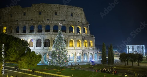 Rome, Italy - illuminated Colosseo at night with christmas tree - Timelapse without motion