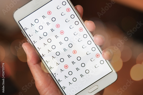 student testing quiz in exercise, exams answer on smart phone or
